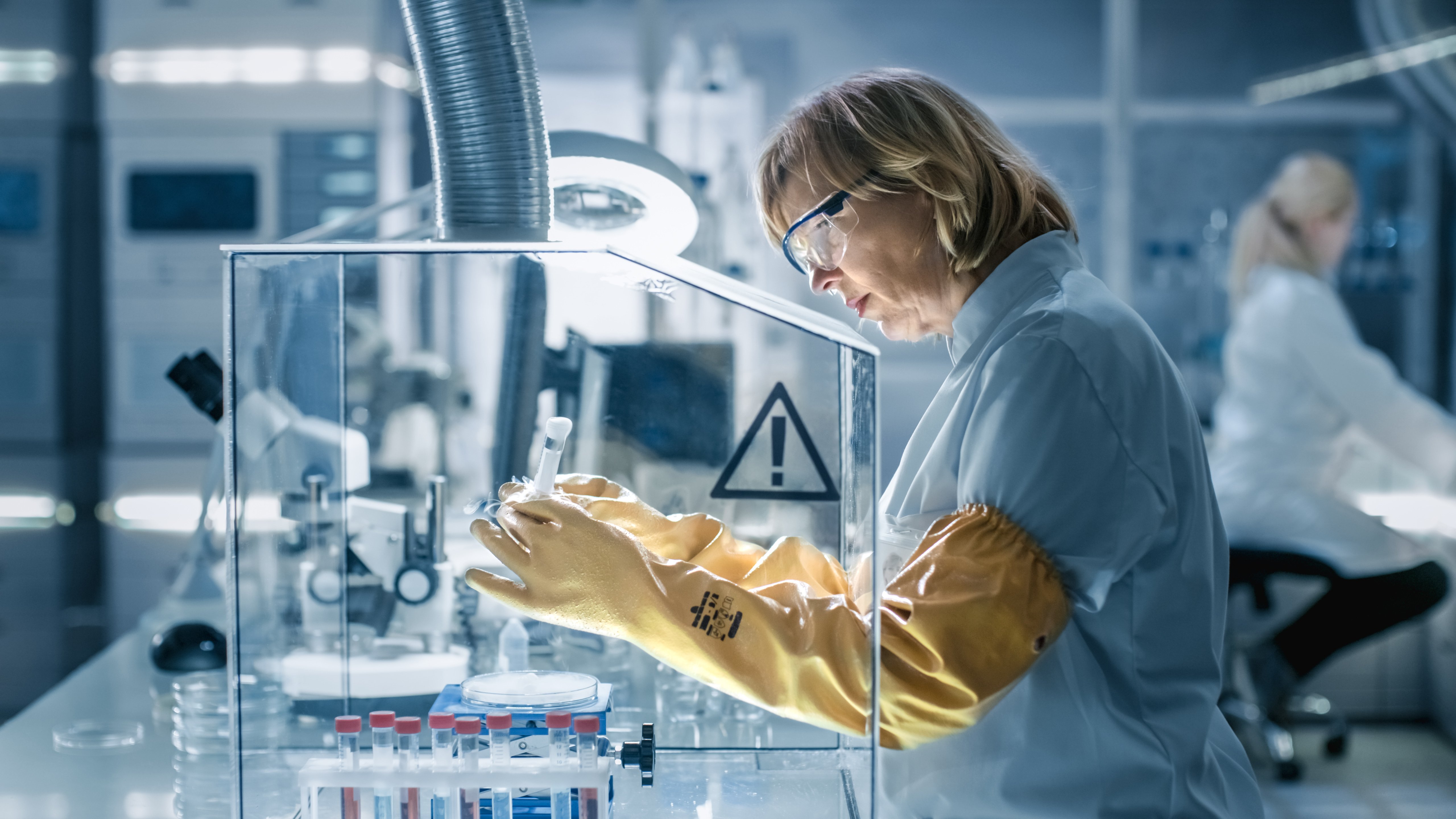 Scientist operating in a glove box