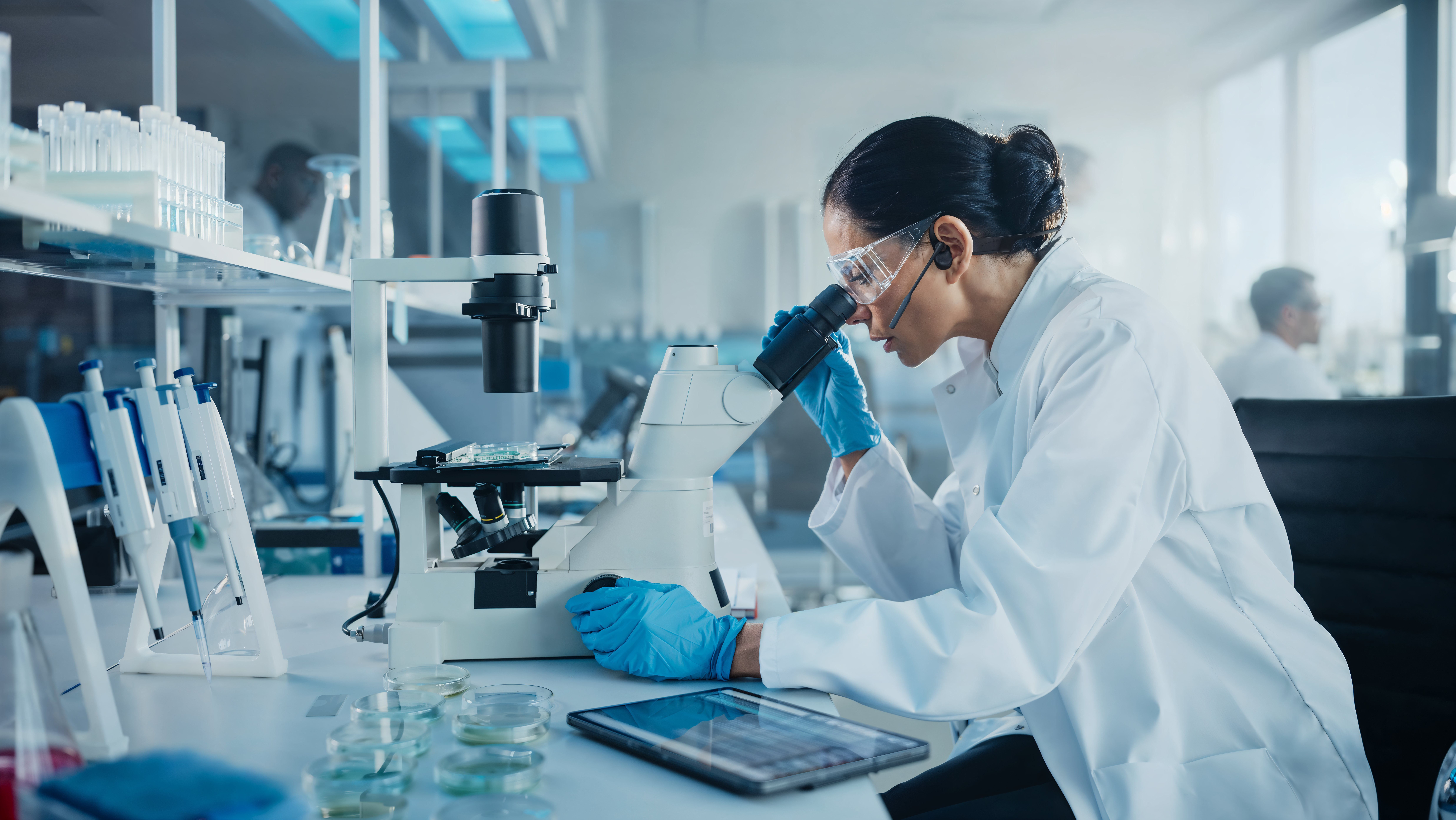 Woman Scientist Lab Microscope Aftershokz Elie_HighDef